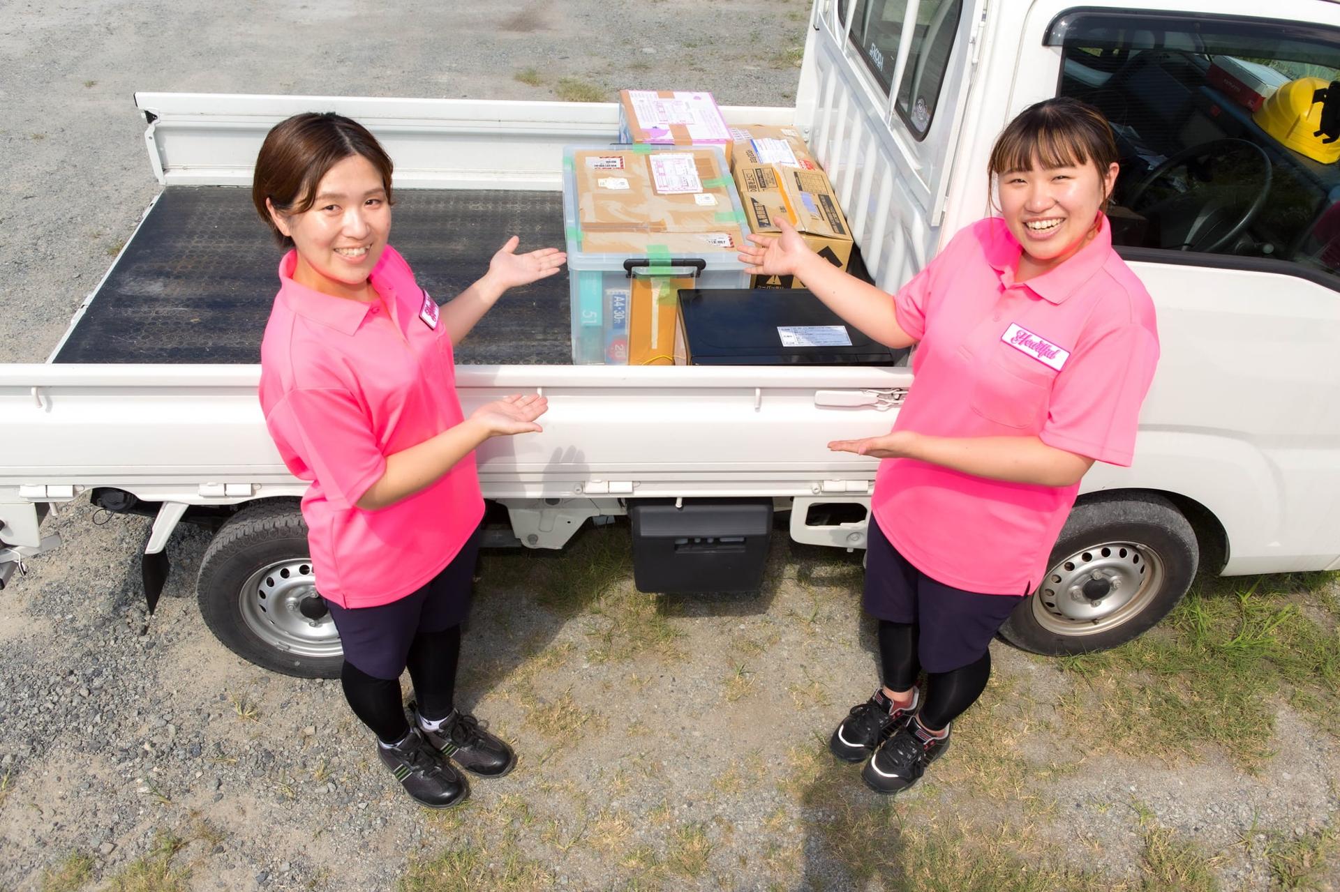 トラックに積んだ不用品とハートフル京都のスタッフ写真